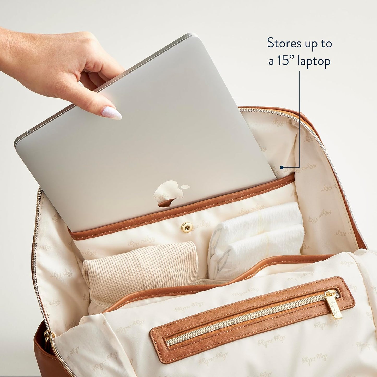 Itzy Ritzy Eras Diaper Bag Backpack – Large Capacity Backpack Diaper Bag Featuring Sleek Design, 15 Pockets, Changing Pad, Stroller Straps, and Luggage Sleeve (Cognac)